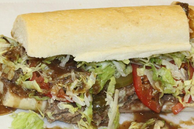 French Quarter walking Food Tour Famous Flavors of New Orleans - Little Vic’s serves muffuletta in a courtyard