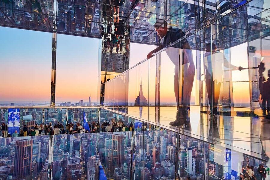 Midtown Manhattan reflected in the glass of an observation deck