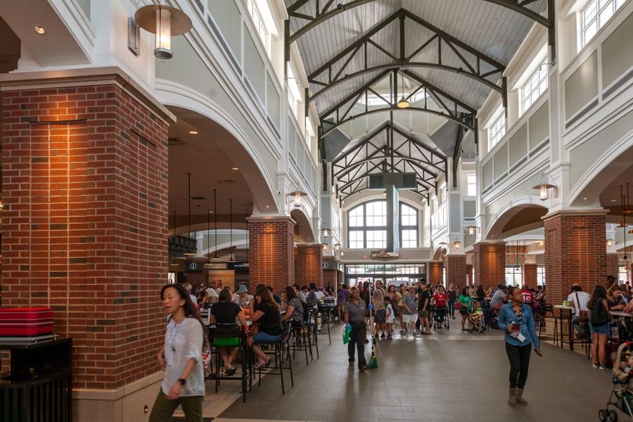 NYC: Woodbury Common Premium Outlets Shopping Trip - Walking through an open-air shopping center