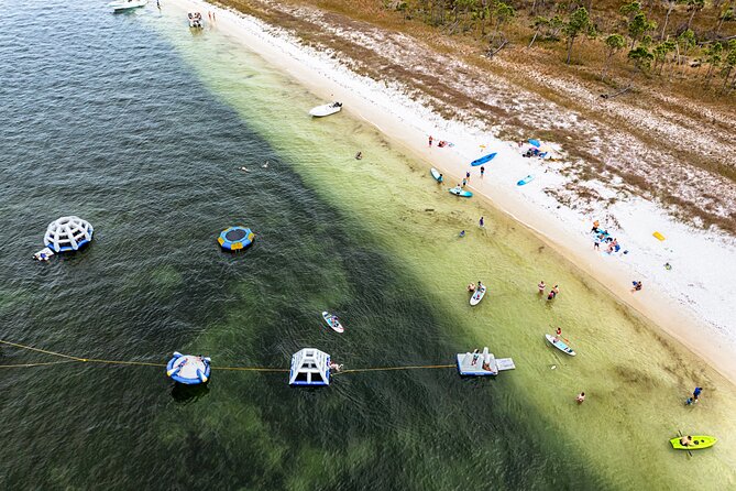 Shell Island Inflatable Adventure Park & Dolphin Sightseeing Tour - Reaching Shell Island’s calmer bay side